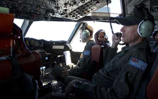 Flying Officer Stuart Doubleday (L) and Warrant Officer Michael Makin sit in the cockpit of a Royal Australian Air Force AP-3C Orion aircraft searching for missing Malaysian Airlines flight MH370 over the southern Indian Ocean on March 27, 2014 off the coast of Perth, Australia. 